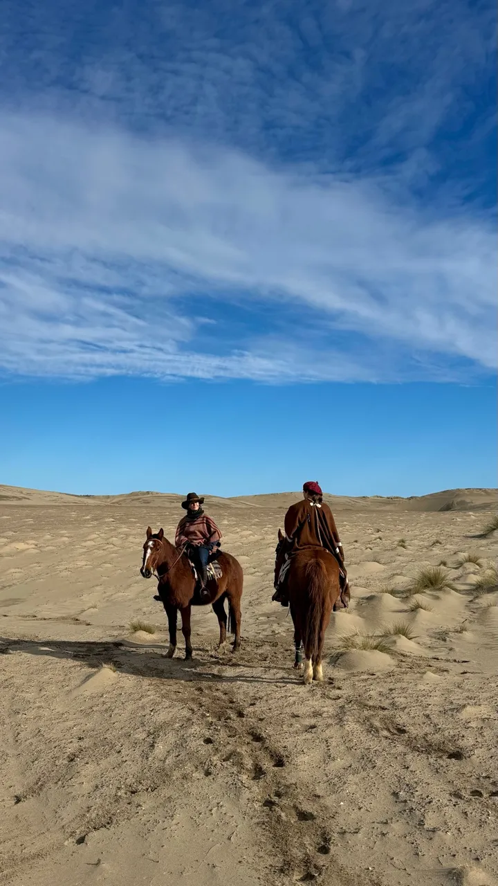 Dos jinetes cruzando los médanos camino a Punta Pardelas
